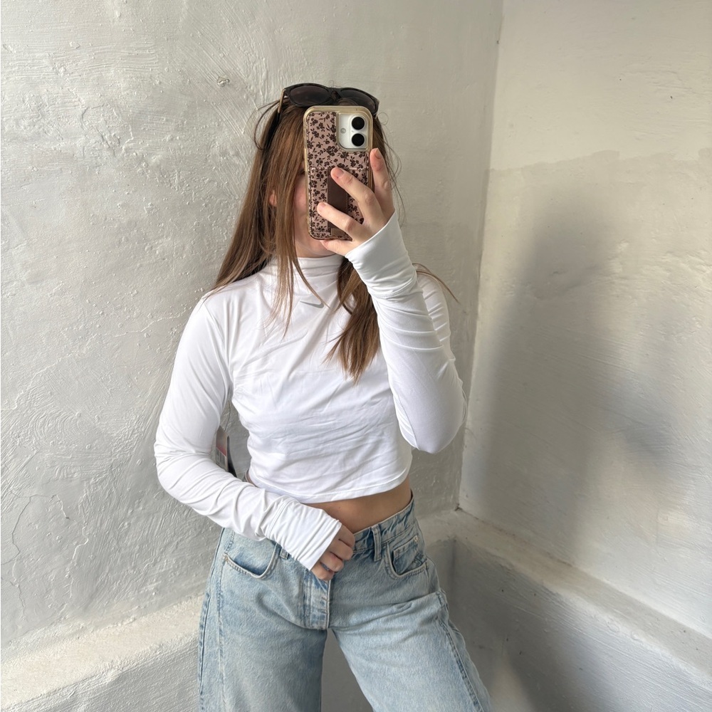 white Nike Dri-FIT One Luxe
Women's Long-Sleeve Cropped Top - Picture 12 of 12